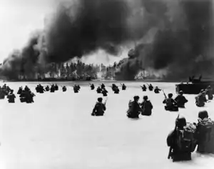 U.S. troops of the 2d Battalion, 165th Infantry, struggle to shore on Yellow Beach on Butaritari (Makin) Island following a naval gunfire bombardment