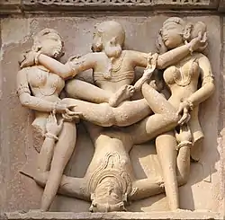 Khajoraho scene of three women and one man.
