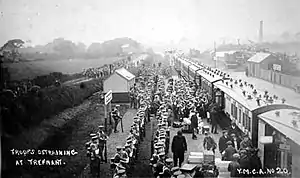 The 4th Battalion King's Own (Royal Lancasters) assemble in rows, after disembarking from a train.