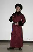A young Manchu man dressed in traditional clothes.