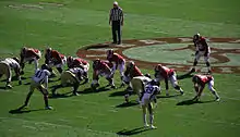 American football players lined up prior to a play