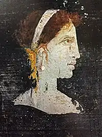 Most likely a posthumous painted portrait of Cleopatra VII of Ptolemaic Egypt with red hair and her distinct facial features, wearing a royal diadem and pearl-studded hairpins, from Roman Herculaneum, mid-1st century AD