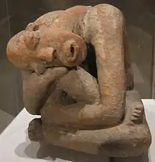 Terracotta seated figure from Mali; 13th century; earthenware; 29.9 cm (113⁄4 in) high; Metropolitan Museum of Art (New York City). The raised marks and indentations on the back of this hunched Djenné figure may represent disease or, more likely, sacrification patterns. The facial expression and pose could depict an individual in mouring or in pain