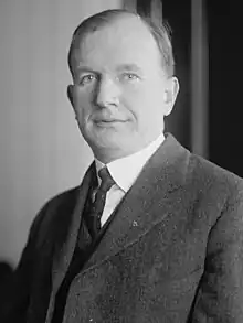 Upper-body portrait of a man in a suit.