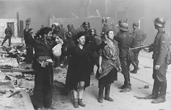 NARA copy #18These bandits offered armed resistanceNowolipie 64 near intersection with Smocza.Woman on the right: Hasia Szylgold-Szpiro