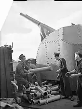 Gunners of HMS Glasgow clearing empty cartridges after a shoot
