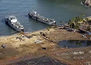 Indonesian Navy landing craft KRI Teluk Banten  (516) and KRI Teluk Langsa (501) and a US Navy Seahawk helicopter in Calang